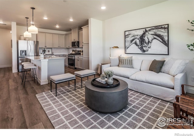 living area with recessed lighting and dark wood-style floors