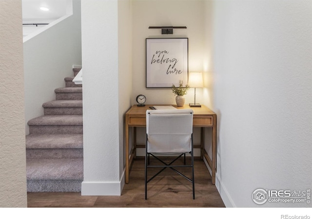 home office featuring baseboards and wood finished floors