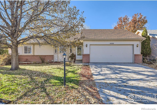 view of front of property featuring a garage and a front lawn