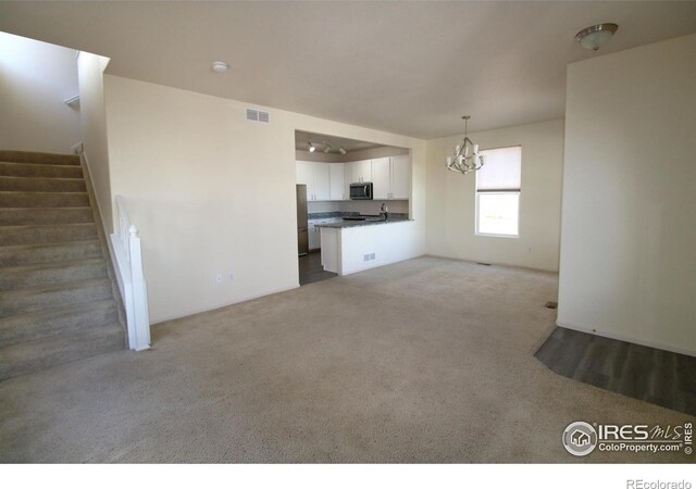 unfurnished living room featuring carpet flooring