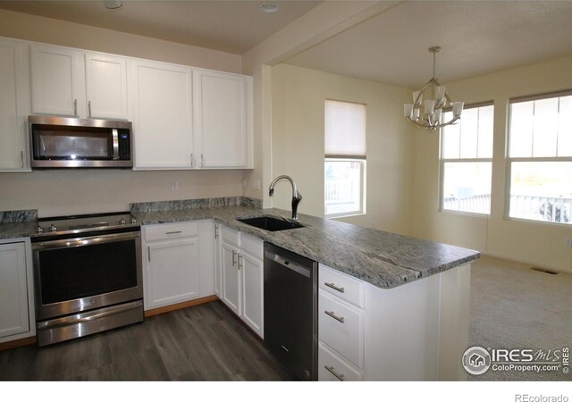 kitchen with white cabinets, kitchen peninsula, sink, and appliances with stainless steel finishes