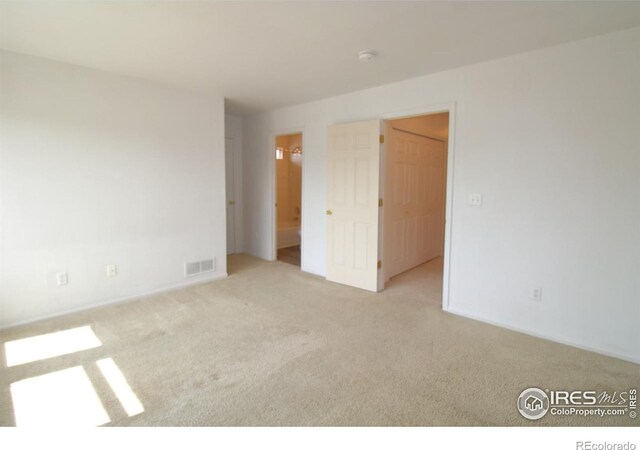 empty room with light colored carpet