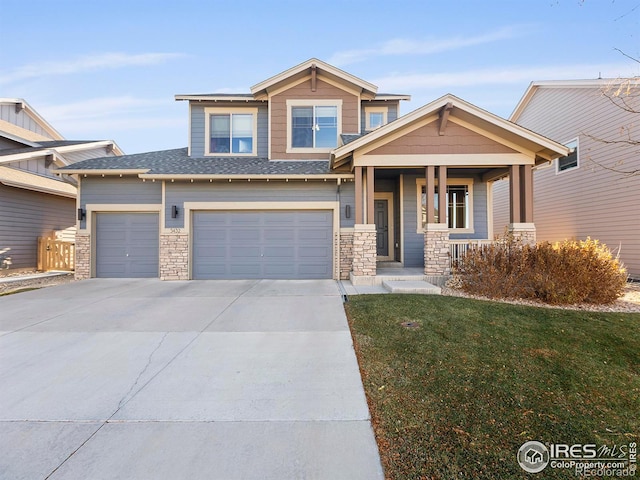 view of front of home featuring a porch, a garage, and a front lawn