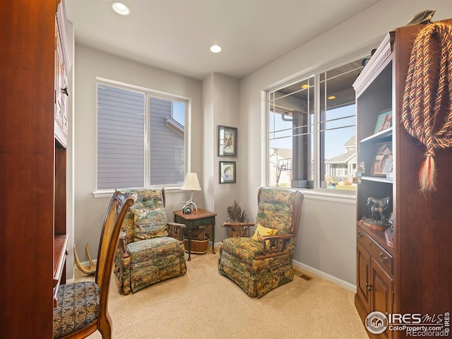 sitting room with carpet flooring and a wealth of natural light