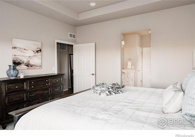 bedroom featuring visible vents and ensuite bathroom