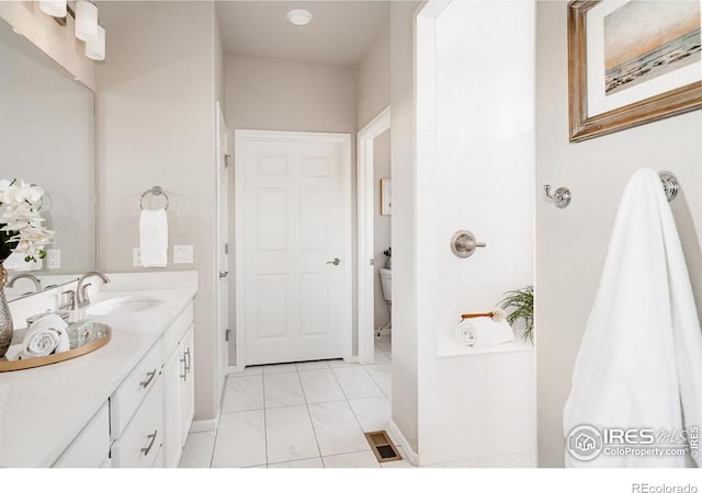 full bathroom featuring marble finish floor, visible vents, vanity, and toilet