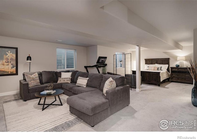 living area featuring light colored carpet and baseboards