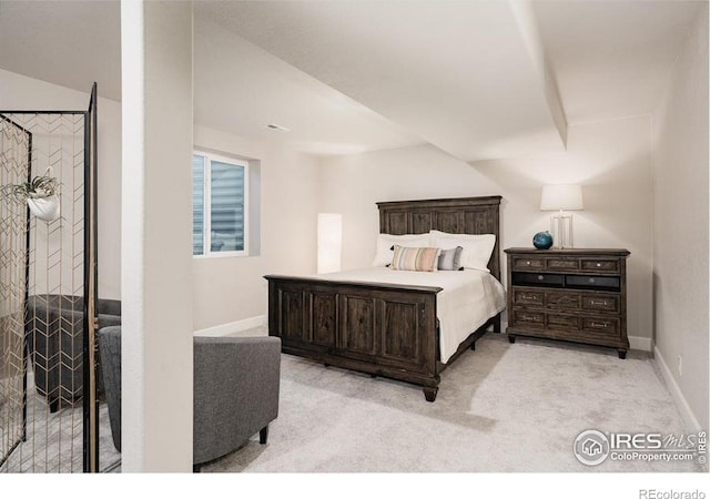 bedroom featuring light carpet and baseboards