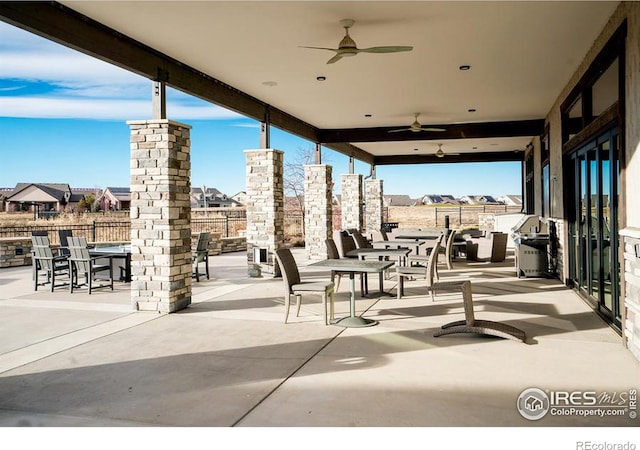 view of patio / terrace with fence, outdoor dining area, and a ceiling fan