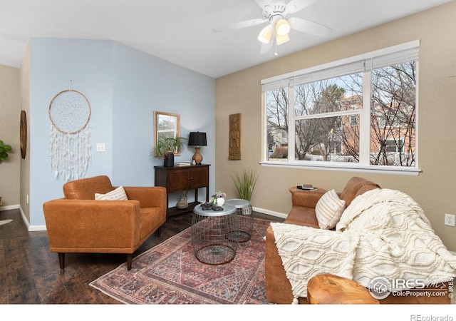 living room featuring dark wood-type flooring and ceiling fan