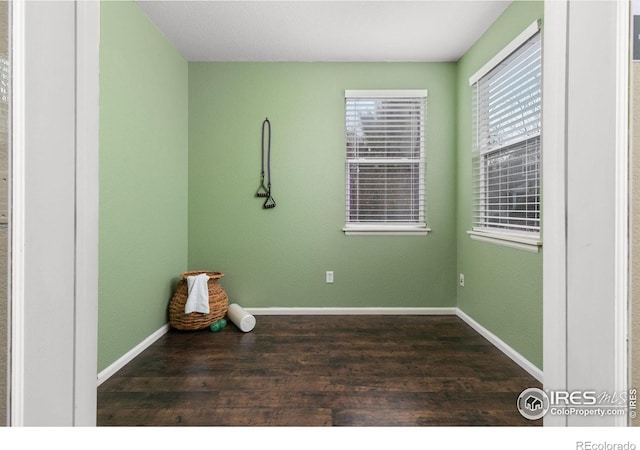 unfurnished room with dark hardwood / wood-style floors