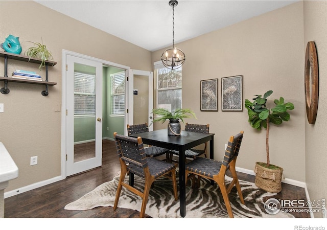 dining area with an inviting chandelier and dark hardwood / wood-style floors