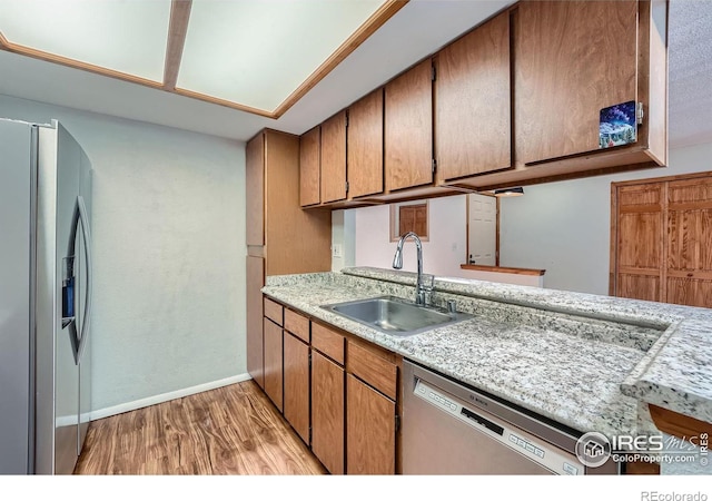 kitchen featuring sink, stainless steel appliances, and light wood-type flooring