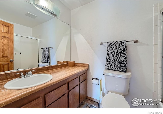 bathroom featuring walk in shower, vanity, and toilet