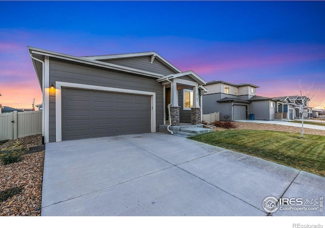 view of front of home with a garage and a yard