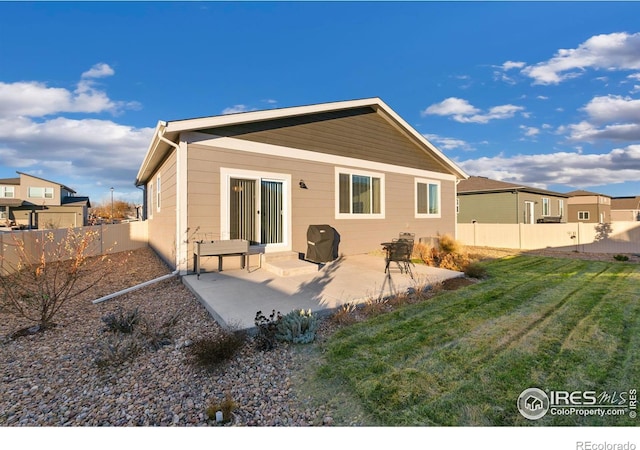 back of house featuring a yard and a patio