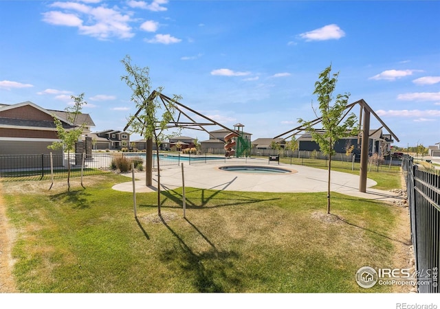 view of swimming pool with a lawn