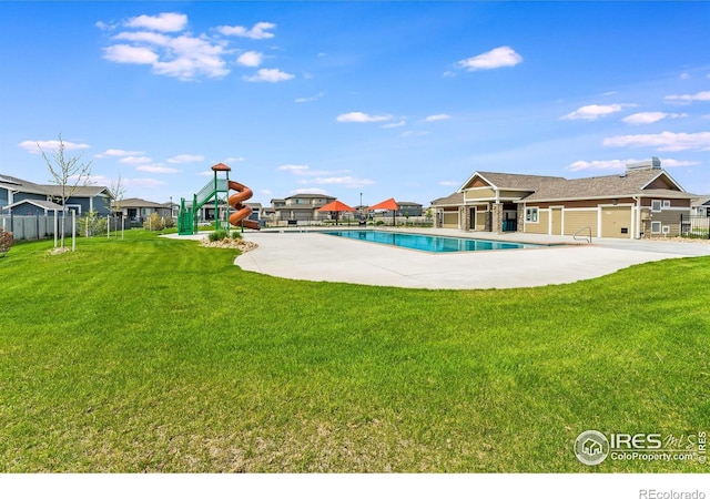 view of pool with a yard, a patio, and a playground