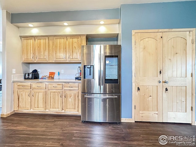 kitchen with dark hardwood / wood-style flooring, stainless steel fridge with ice dispenser, and light brown cabinets