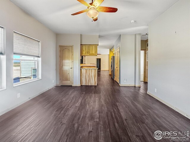 unfurnished living room with ceiling fan and dark hardwood / wood-style floors