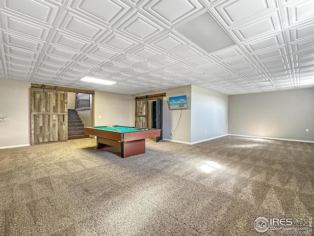 recreation room featuring carpet flooring, a barn door, and billiards