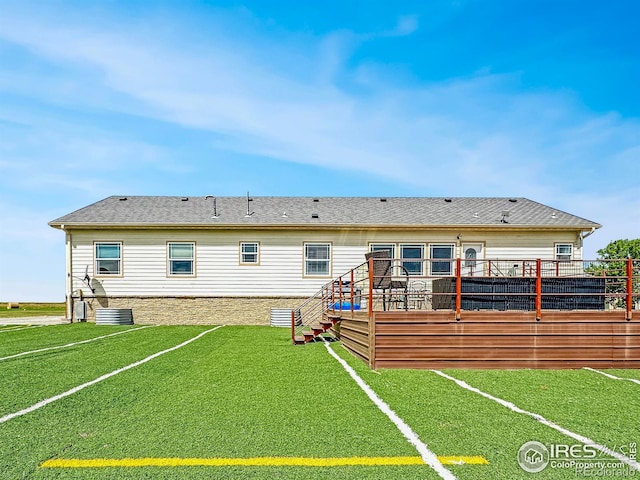 rear view of house featuring a yard