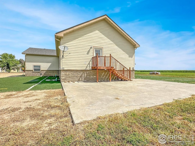 back of property with a patio area and a lawn