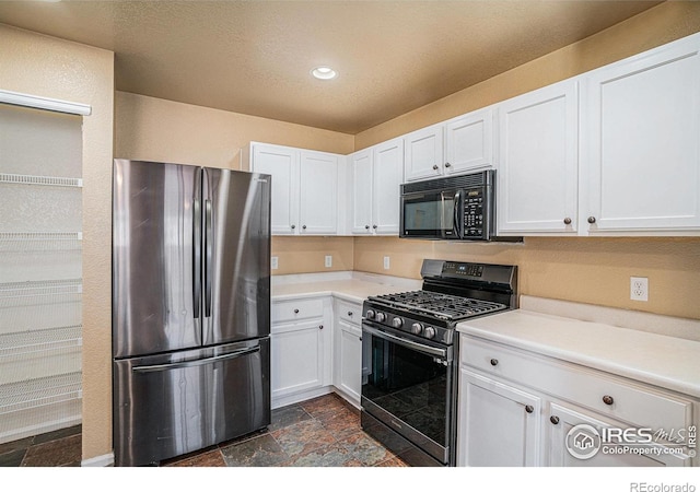 kitchen featuring white cabinetry and black appliances