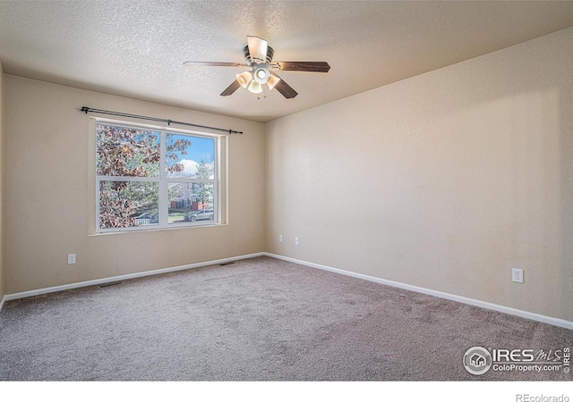 spare room featuring ceiling fan, carpet floors, and a textured ceiling