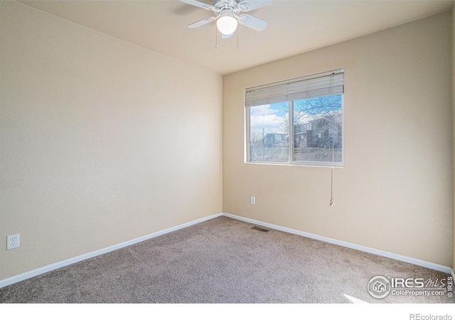 carpeted spare room with ceiling fan