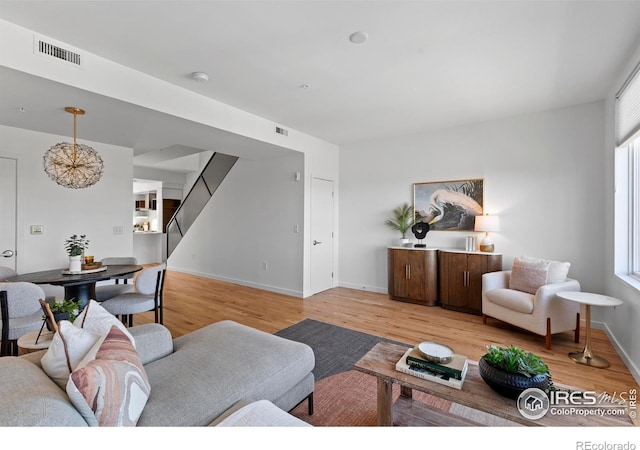 living room featuring a healthy amount of sunlight and light hardwood / wood-style flooring