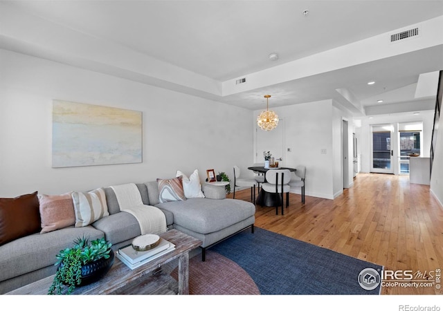 living room featuring hardwood / wood-style floors and a chandelier