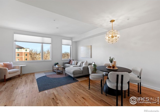 dining room with a notable chandelier and light hardwood / wood-style flooring