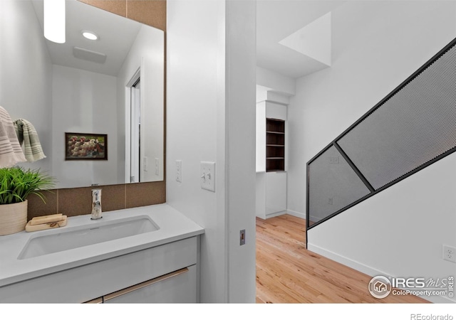 bathroom with vanity and wood-type flooring