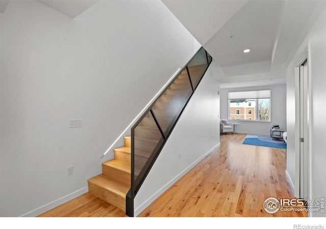 stairs with hardwood / wood-style floors