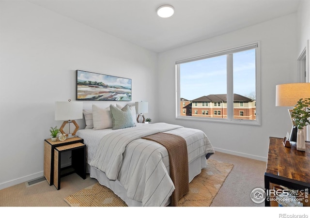 bedroom featuring light colored carpet