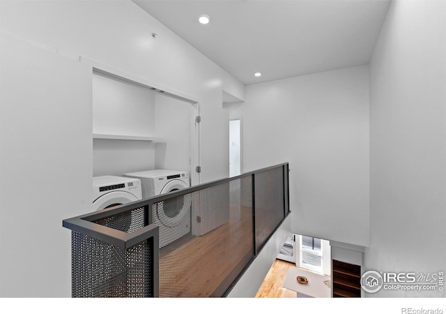 interior space featuring wood-type flooring and washer and clothes dryer