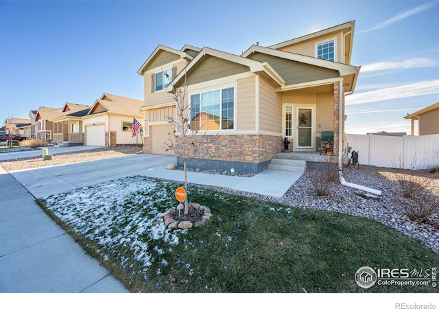 craftsman house with a garage and a front lawn