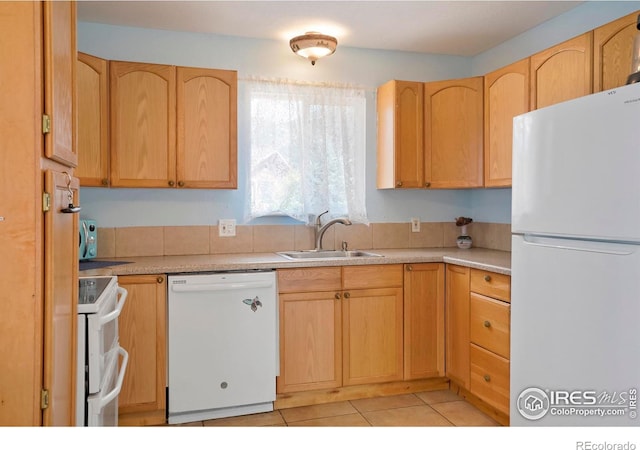 kitchen featuring light tile patterned floors, white appliances, light brown cabinets, and sink