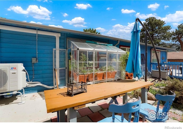 deck with a sunroom and ac unit