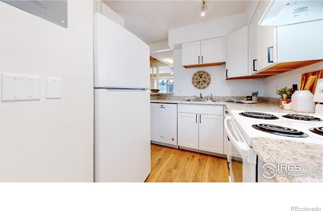 kitchen with exhaust hood, white cabinets, light hardwood / wood-style floors, and white appliances