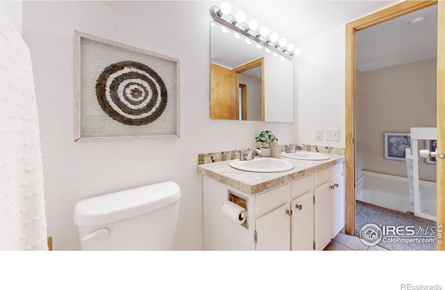 bathroom featuring tile patterned floors, vanity, and toilet