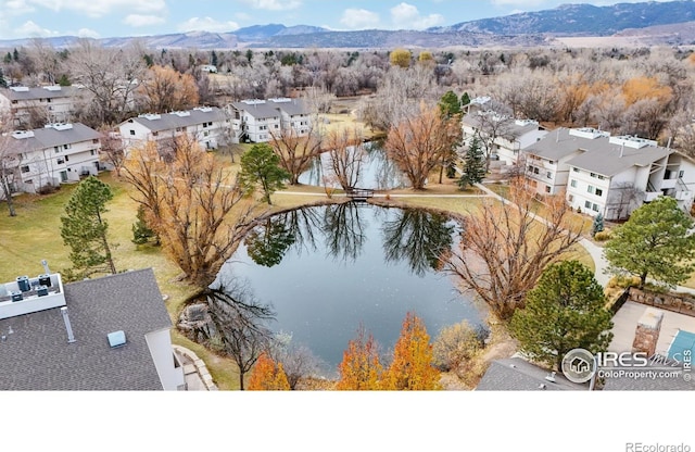 birds eye view of property with a water and mountain view