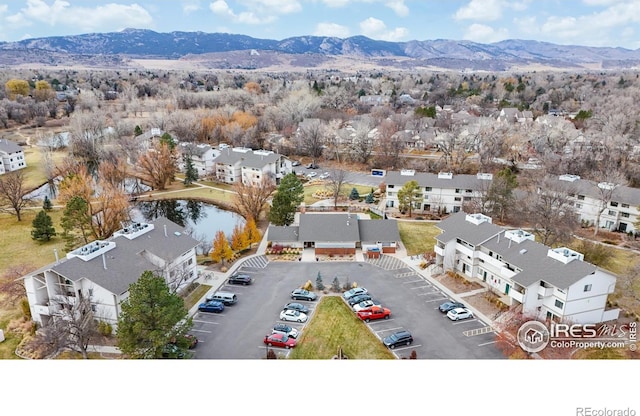 drone / aerial view featuring a water and mountain view