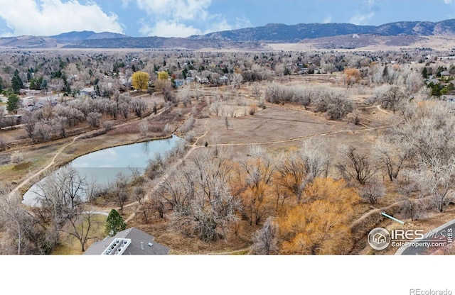 drone / aerial view with a water and mountain view