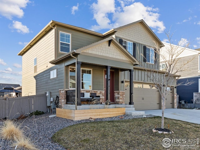 craftsman inspired home featuring covered porch and a garage