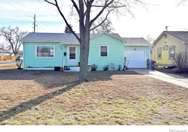 ranch-style home with a garage and a front lawn