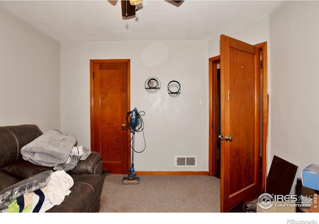 living room with ceiling fan and carpet floors