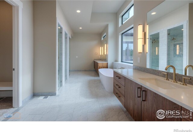 bathroom featuring a freestanding tub, recessed lighting, vanity, baseboards, and a shower stall