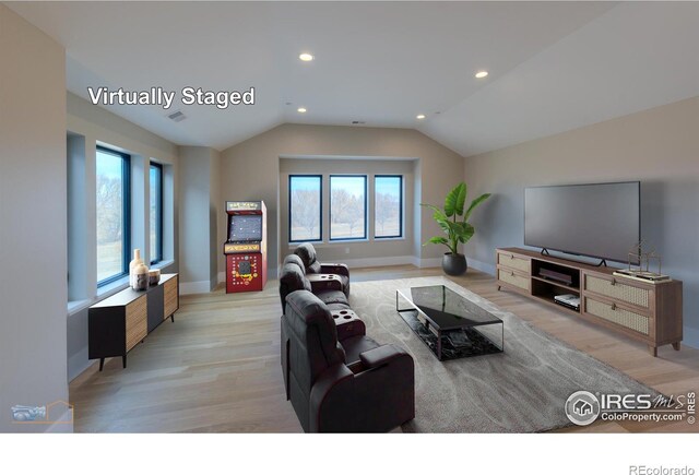 living area featuring lofted ceiling, light wood-style floors, plenty of natural light, and recessed lighting